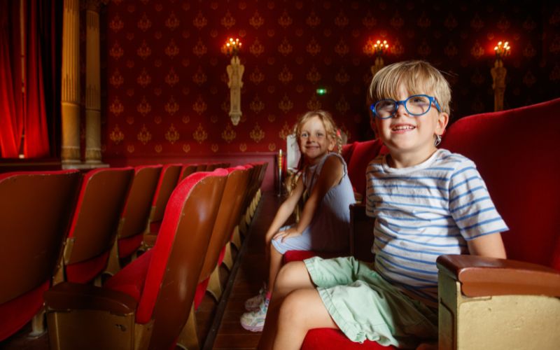 Zdjęcie przedstawia dzieci w teatrze