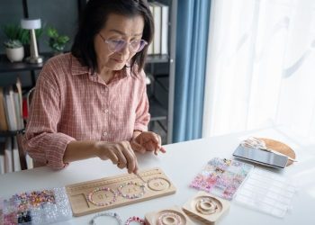 Seniorka tworząca biżuterię z koralików – mikrodotacje dla seniorów Poznań